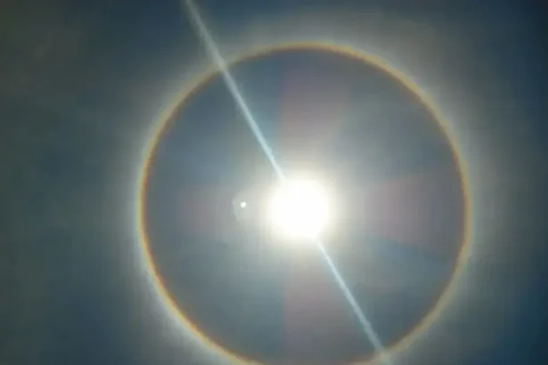 A photo of the sun with the rainbow ring around indicating heat