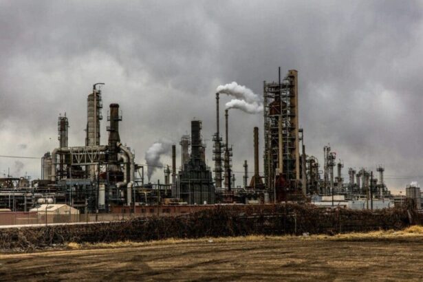 Chemical disasters. Climate change a factory expelling pollution into a dark, dismal sky