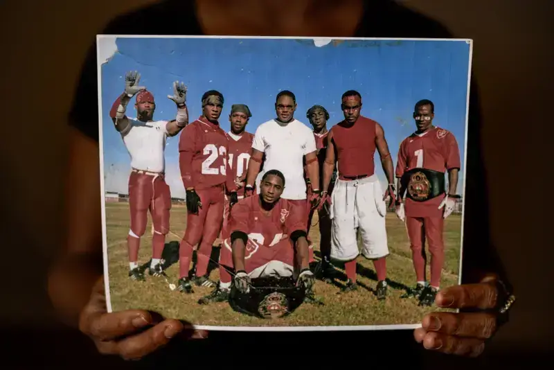 Louisiana prisons someone holding a photo of kentrell on the prison football team.