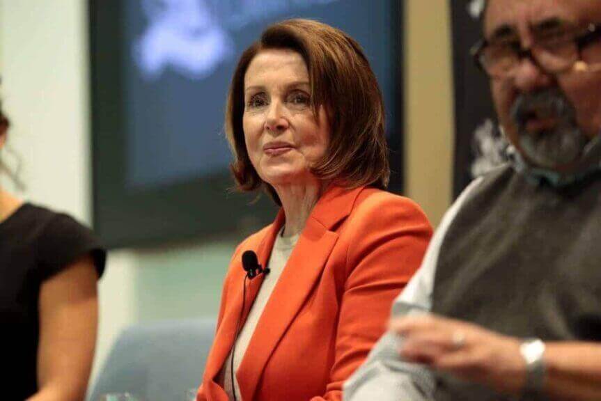 2026 midterms nancy pelosi wearing an orange jacket