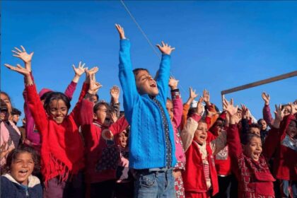 Children in Gaza cheering with arms raised