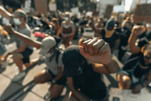 Protesters kneeling with fists in the air