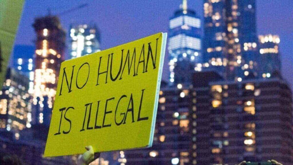 Immigration and daca protections protest sign that says no human is illegal