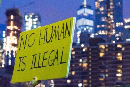 Immigration and daca protections protest sign that says no human is illegal