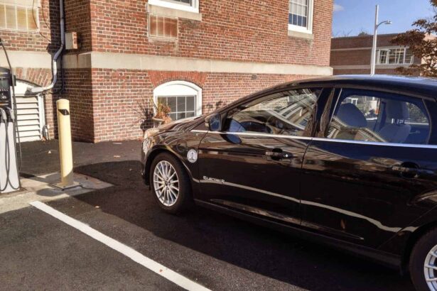 Electric vehicle parked at a charging station in a parking lot.