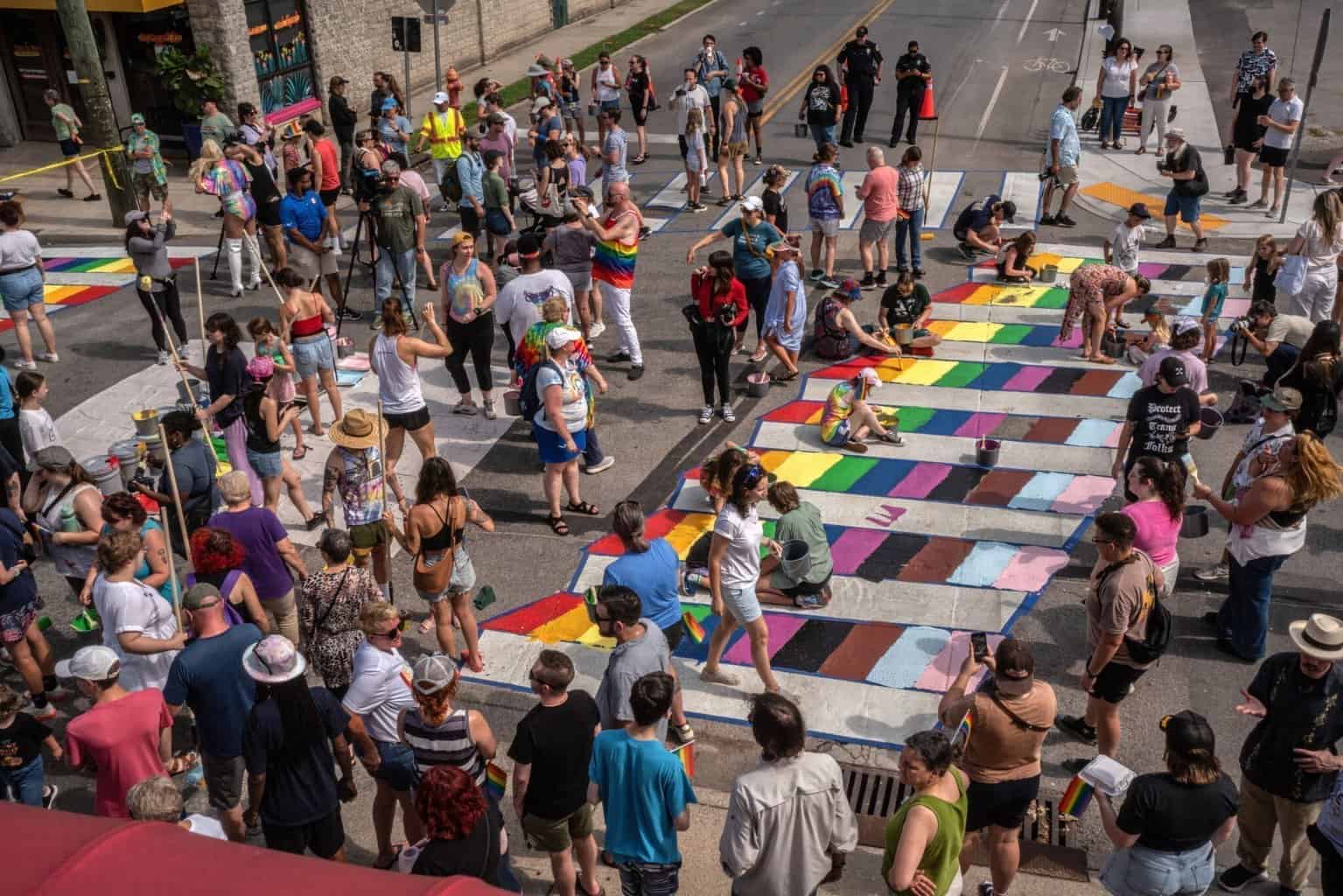 More than 100 people on Saturday painted crosswalks in the colors of the LGBTQ Pride flag at the intersection of 14th and Woodland Streets. in East Nashville.