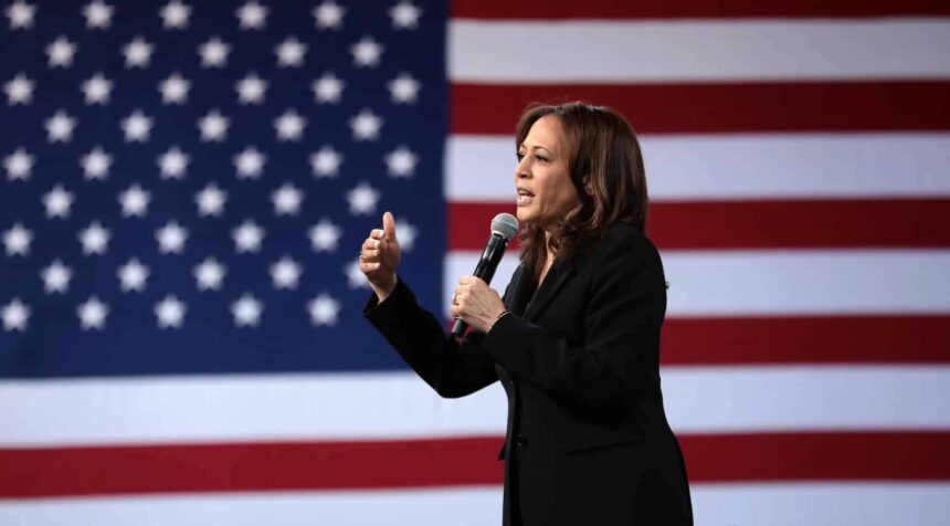 Kamala harris speaking in front of the american flag