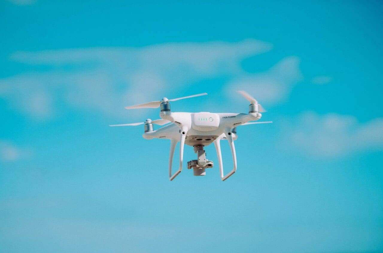 Drone flying in a bright blue sky