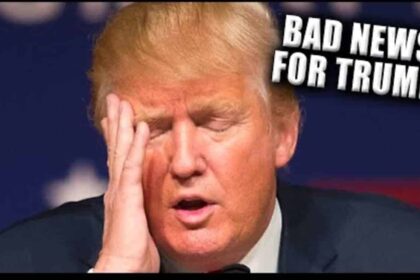 Donald Trump with his head in his hand, eyes closed