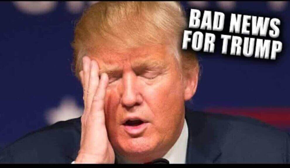 Donald Trump with his head in his hand, eyes closed