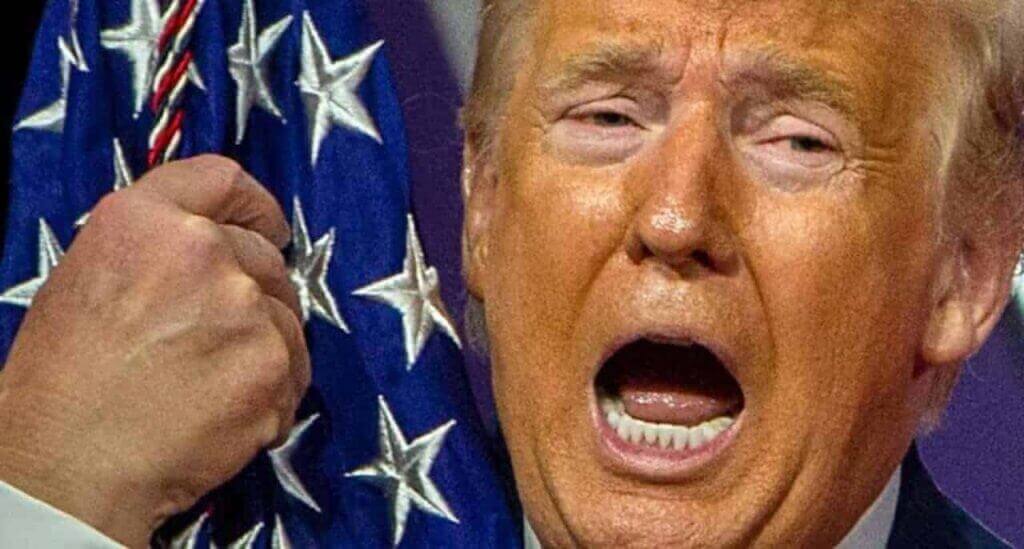 Closeup of Trump's face as he hugs the American flag