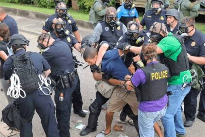 Filming police is getting closer to being outlawed, police wrangling people during a protest with one using a chokehold.