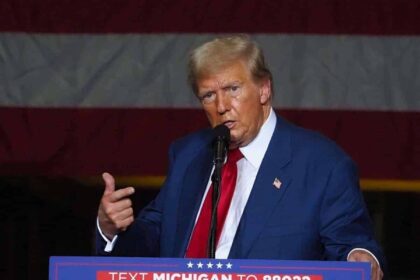 Trump on stage at a rally in Michigan
