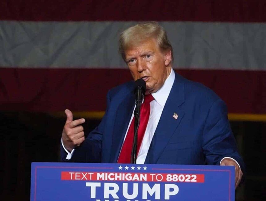 Trump on stage at a rally in michigan