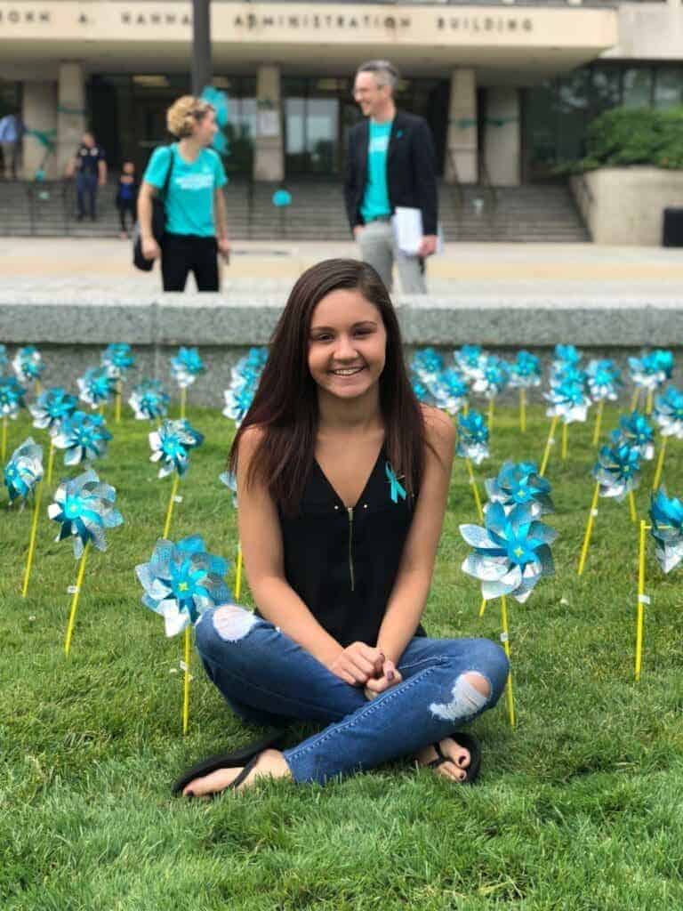 img 3266 768x1024 1 Former gymnast kaylee lorincz sits outside the hannah administration building on michigan state university campus in 2018 surrounded by teal pinwheels placed to represent support for survivors of ex-msu and olympic doctor larry nassar.