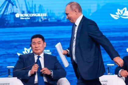 Russian President Vladimir Putin walks past Mongolia’s prime minister, Luvsannamsrain Oyun-Erdene.