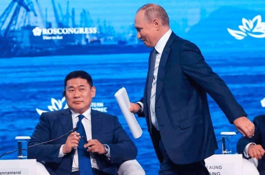 Russian president vladimir putin walks past mongolia’s prime minister, luvsannamsrain oyun-erdene.