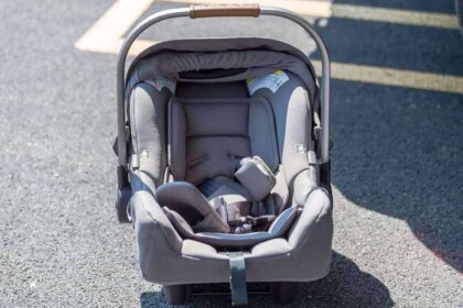 A child carseat sitting on the pavement