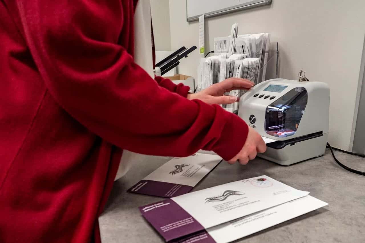 What will happen on election night An election worker in Snyder County stamps voters' mail ballots that have been returned in the 2024 primary election. A ruling by the state Supreme Court restored the requirement that mail voters write the date on their ballot envelope for the ballot to be counted.