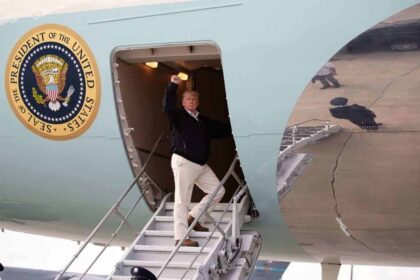 Donald Trump raising his fist as he boards a plane