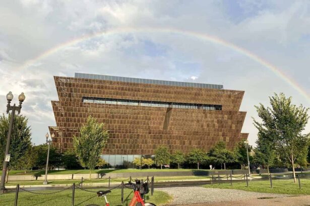 Red rideshare bike with a rainbow in the sky in the background