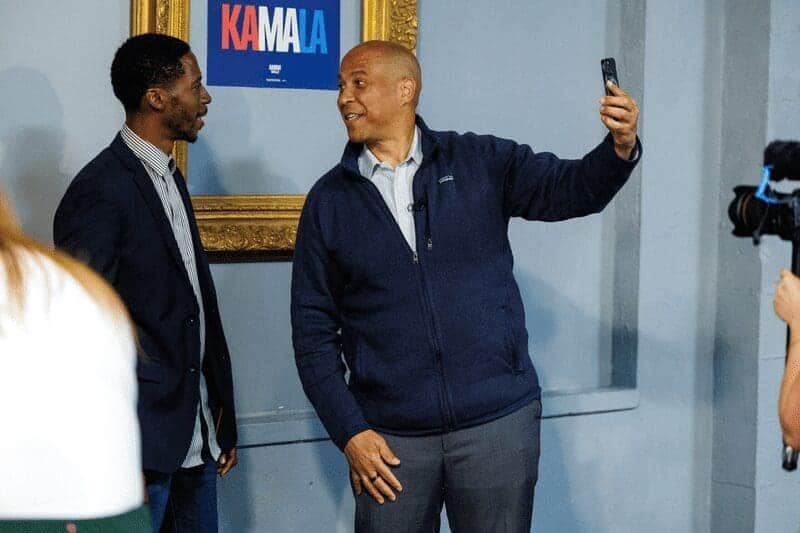 u.s. sen. cory booker (d-n.j.), right, films social media content with poke bowl co-owner jeron dotson, left, after a roundtable with small business owners in flint, mich., on sept. 20, 2024. U. S. Sen. Cory booker (d-n. J. ), right, films social media content with poke bowl co-owner jeron dotson, left, after a roundtable with small business owners in flint, mich. , on sept. 20, 2024.
