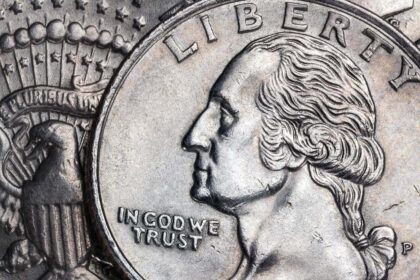 Close up of an American coin with the words In God We Trust on it.
