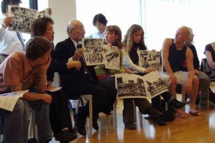 A hibakusha, a survivor of the atomic bombing of Nagasaki, tells young people about his experience and shows pictures. United Nations building in Vienna, during the NPT PrepCom 2007.