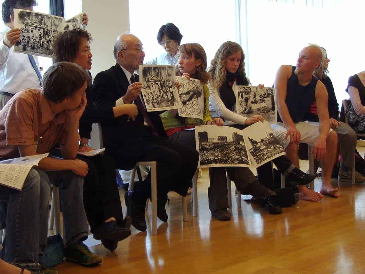 A hibakusha, a survivor of the atomic bombing of Nagasaki, tells young people about his experience and shows pictures. United Nations building in Vienna, during the NPT PrepCom 2007.