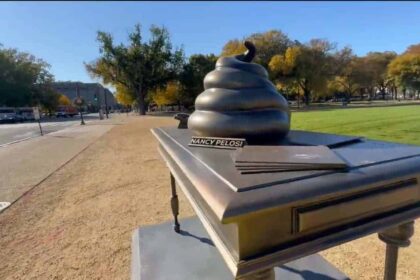 An art display of Nancy Pelosi’s desk with poop on it