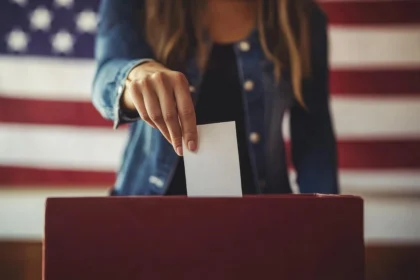 Woman putting a ballot in a ballot box