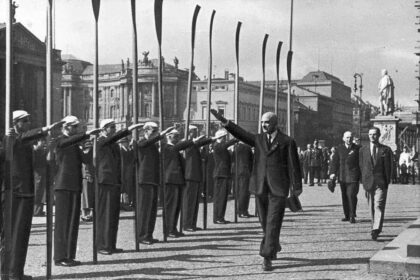 1935 European Rowing Championships in Berlin: Rico Fioroni, the president of FISA, gives a Nazi salute to rowing delegates before laying a wreath on the Tomb of the Unknown Soldier.