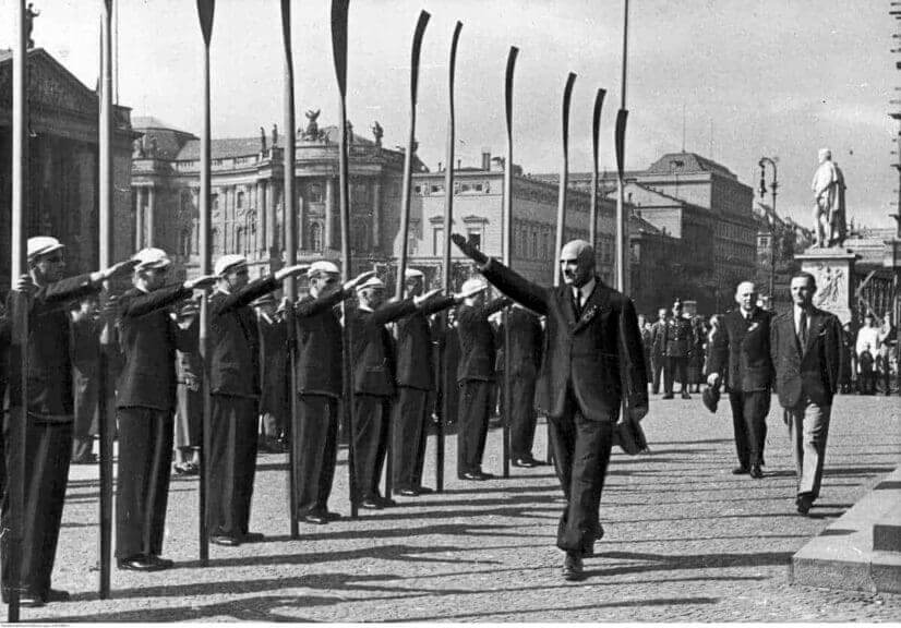 1935 european rowing championships in berlin: rico fioroni, the president of fisa, gives a nazi salute to rowing delegates before laying a wreath on the tomb of the unknown soldier.