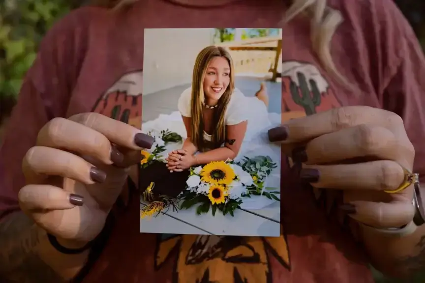 Mother holds photo of 18-year-old daughter who died in texas