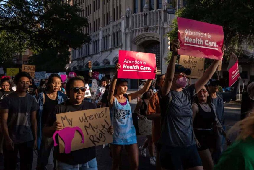Thousands of people walk in a march in support of abortion rights near downtown san antonio