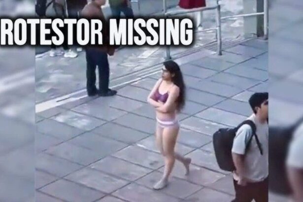 Woman walking down the street in her bra and underwear in protest in iran