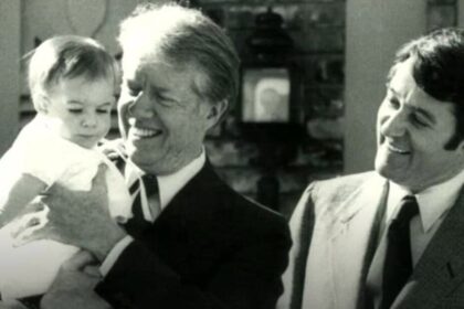 Jimmy Carter holding Mayor Larry Wade's daughter, Elizabeth in 1979 during a visit to Elk City, OK.