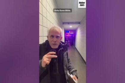 Celebrity speaking to the camera at a Trump rally