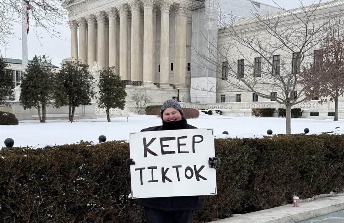 tiktok ban protester Woman holding a sign in front of the supreme court that says keep tiktok