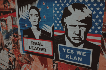 Posters and graffiti on a building in Mexico. Posters feature Mexican and U.S. leaders. Mexican president’s poster says REAL LEADER. Donald Trump poster SATs YES WE KLAN