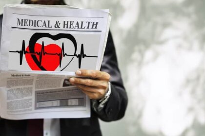 man in suit holding a newspaper with MEDICAL & HEALTH headline