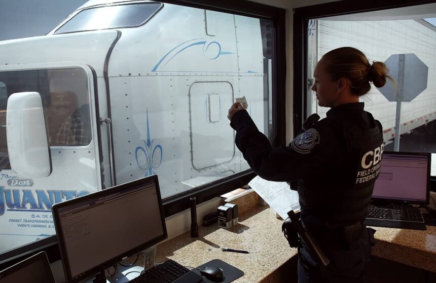 A u. S. Customs and border protection officer checks the identification of truck driver as he passes through the u. S. Checkpoint of the cargo pre-inspection at the otay mesa, calif. , port of entry, june 22, 2016. On any given day, several hundred trucks line up on the mexican side of the border to deliver imports ultimately awaiting the process of screening by customs officers.