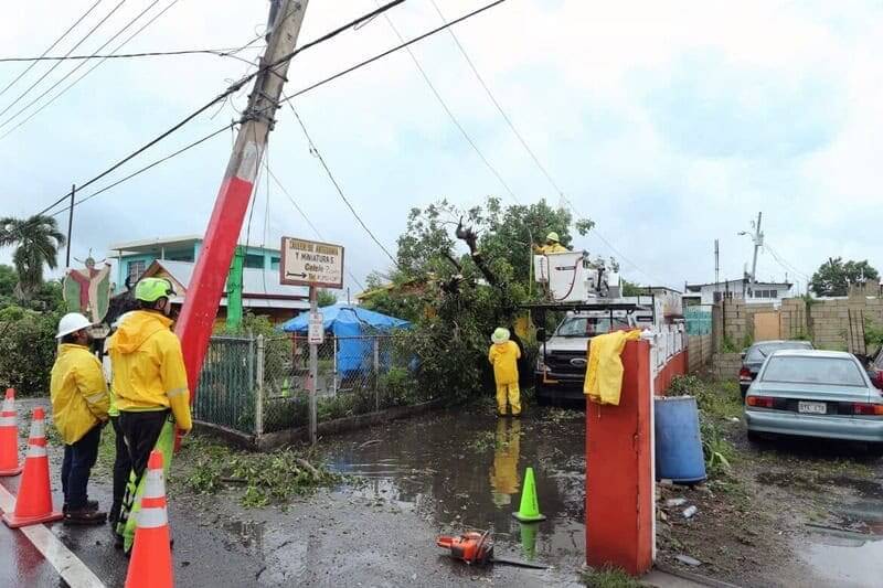 Downed power lines and tree branches a clean up crew is working