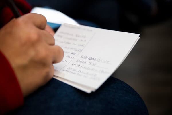 writes postcard Woman writing postcard to stop medicaid cuts
