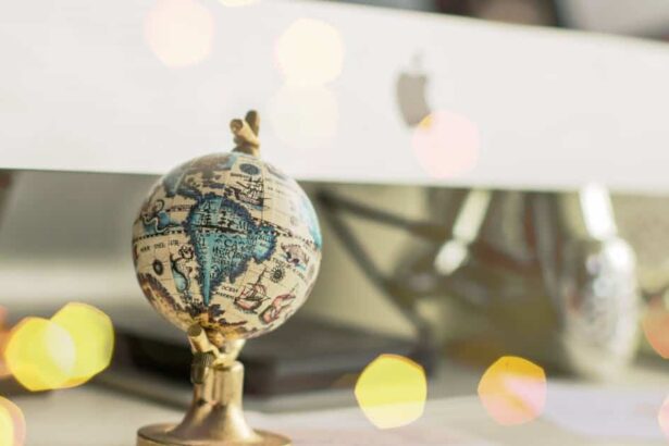 Close-up of a miniature globe on an office desk with a bokeh light effect, creating a dreamy atmosphere.
