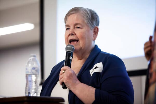 woman speaking healthcare town hall Woman speaking against medicaid cuts