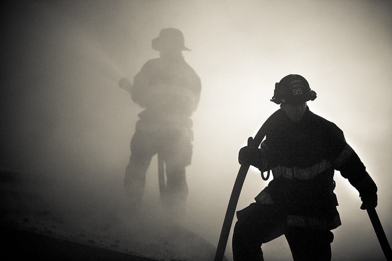 Firefighters surrounded by smoke