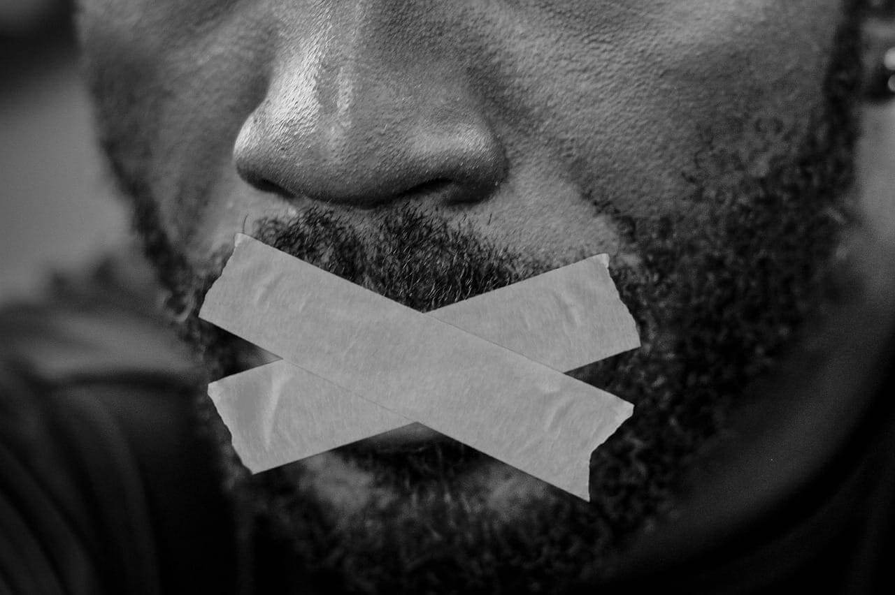 Black laws a black man with his mouth taped shut