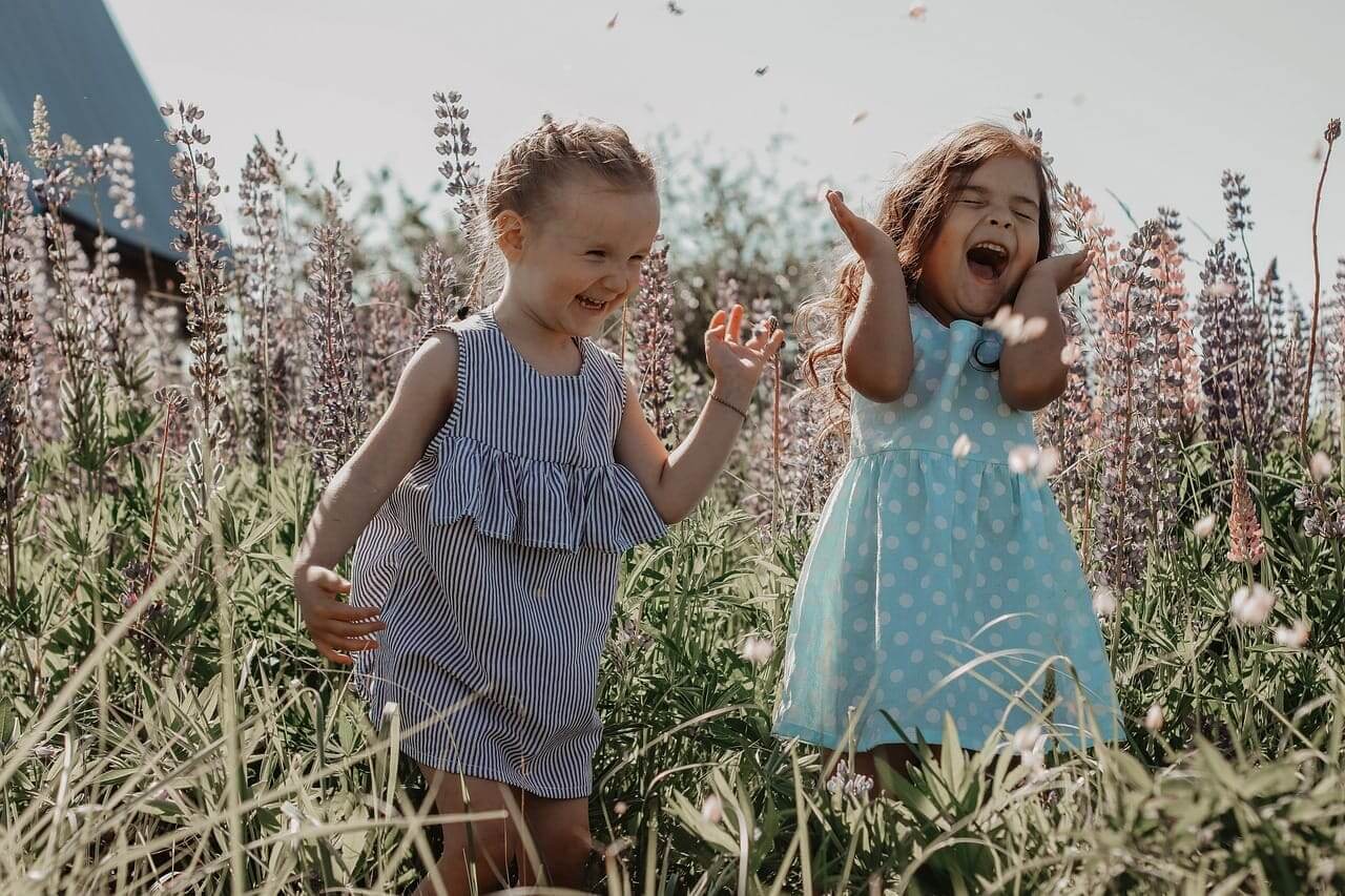Happy little girls in a flower field