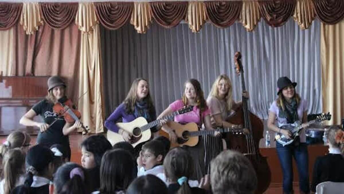 The bluegrass group Della Mae plays at an orphanage in Kyrgyzstan on its State Department-sponsored American Music Abroad tour in 2012.